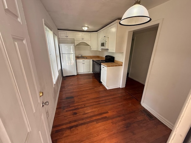 418 W 3rd St, Columbia, TN 38401 - kitchen featuring white appliances, white cabinets, dark wood finished floors, light countertops, and pendant lighting