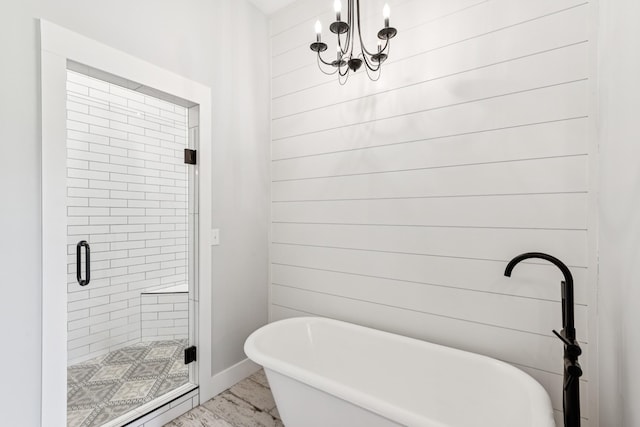 2427 Green Valley Rd, Lafayette, TN 37083 - full bath with marble look tiles, a freestanding tub, a shower stall, and a chandelier