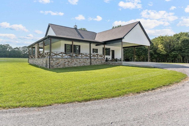2427 Green Valley Rd, Lafayette, TN 37083 - view of front facade featuring a front yard, driveway, an attached carport, covered porch, and roof with shingles