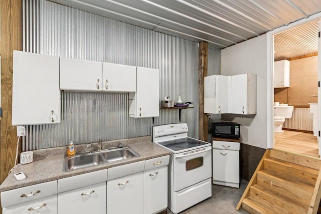 2427 Green Valley Rd, Lafayette, TN 37083 - kitchen with white range with electric cooktop, white cabinets, and black microwave