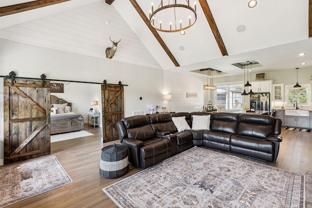 2427 Green Valley Rd, Lafayette, TN 37083 - living area featuring a barn door, high vaulted ceiling, a chandelier, wood finished floors, and beamed ceiling