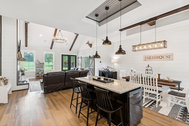 2427 Green Valley Rd, Lafayette, TN 37083 - kitchen with wood finished floors, a chandelier, beam ceiling, light stone countertops, and a kitchen breakfast bar