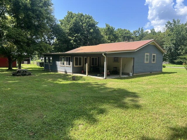 1775 Old Beech Creek Rd, Waynesboro, TN 38485 - back of property with a lawn, a metal roof, a patio area, and crawl space