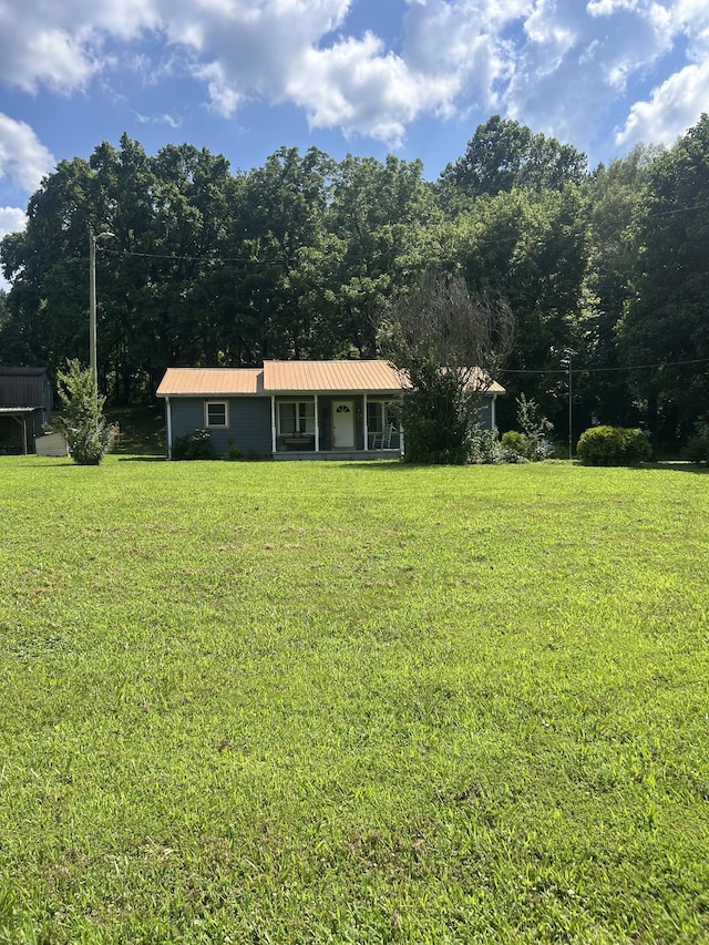 1775 Old Beech Creek Rd, Waynesboro, TN 38485 - view of front of property featuring a front yard, a metal roof, and a porch