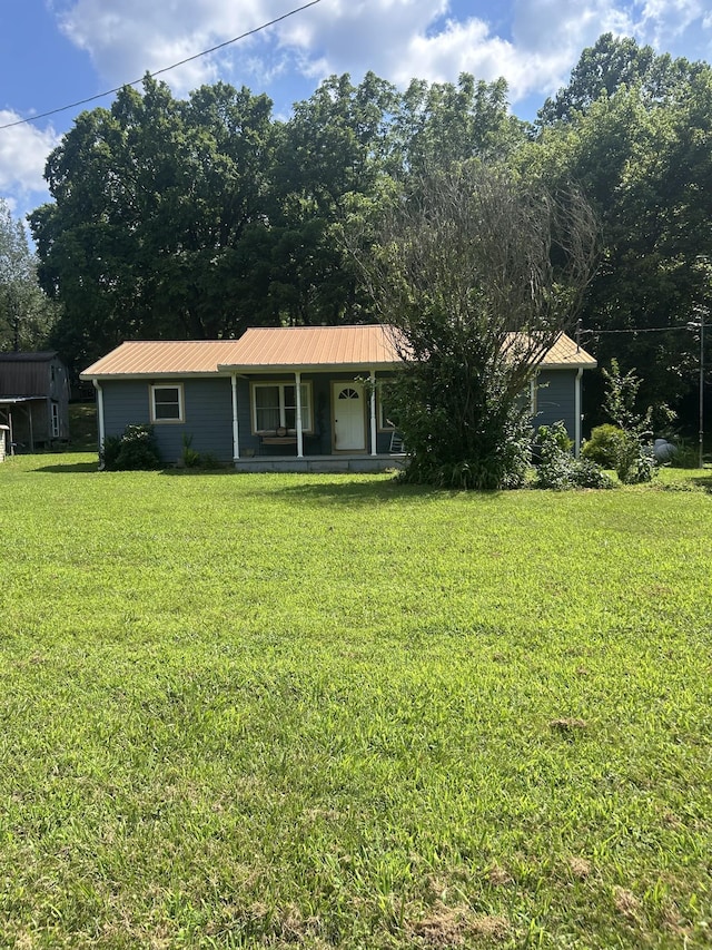 1775 Old Beech Creek Rd, Waynesboro, TN 38485 - view of front facade with covered porch, a front lawn, and a metal roof