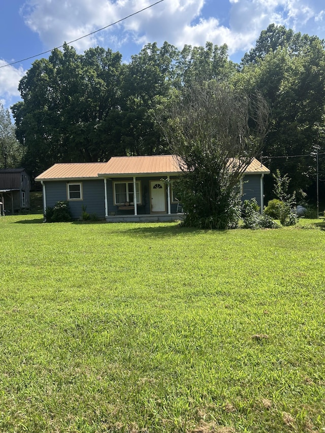 1775 Old Beech Creek Rd, Waynesboro, TN 38485 - view of front of house featuring a porch, a front yard, and a metal roof