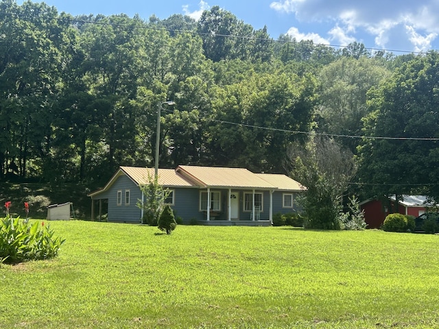 1775 Old Beech Creek Rd, Waynesboro, TN 38485 - ranch-style home with covered porch, a front yard, a metal roof, and a view of trees