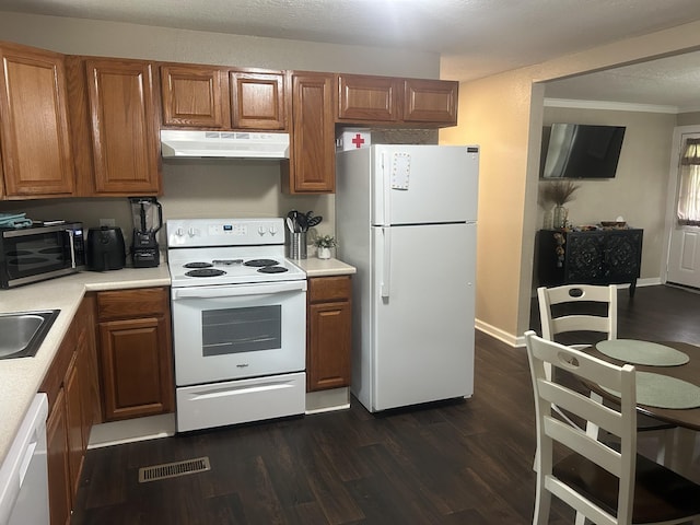 273 E Lake St, Camden, TN 38320 - kitchen featuring white appliances, under cabinet range hood, light countertops, brown cabinetry, and dark wood-style floors