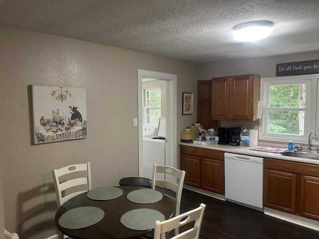 273 E Lake St, Camden, TN 38320 - kitchen with white dishwasher, a textured ceiling, light countertops, dark wood-style floors, and washer / dryer