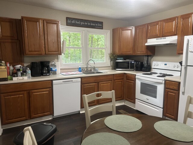 273 E Lake St, Camden, TN 38320 - kitchen featuring white appliances, under cabinet range hood, and brown cabinets