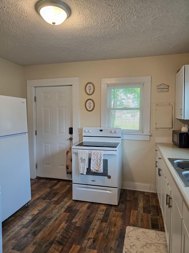 103 Oak St, Portland, TN 37148 - kitchen with white appliances, dark wood finished floors, white cabinetry, a textured ceiling, and light countertops