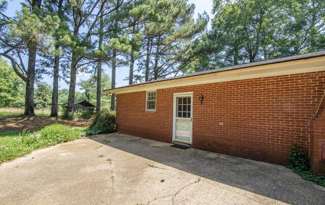 867 Lexington Hwy, Loretto, TN 38469 - view of side of property featuring brick siding and a patio area
