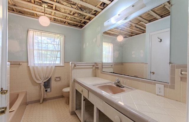 867 Lexington Hwy, Loretto, TN 38469 - bathroom with a wainscoted wall, tile walls, a tub to relax in, vanity, and tile patterned flooring
