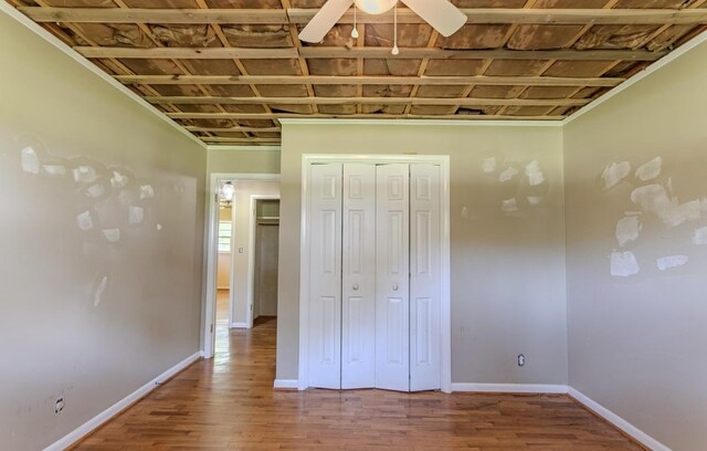 867 Lexington Hwy, Loretto, TN 38469 - unfurnished bedroom with wood finished floors, a closet, and a ceiling fan
