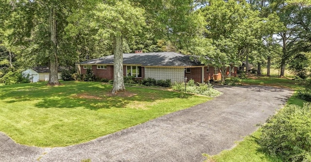 867 Lexington Hwy, Loretto, TN 38469 - ranch-style home featuring a front yard, brick siding, a chimney, and asphalt driveway