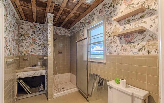 867 Lexington Hwy, Loretto, TN 38469 - full bath with wallpapered walls, tile walls, a stall shower, wainscoting, and vanity