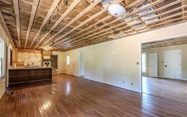 867 Lexington Hwy, Loretto, TN 38469 - unfurnished living room with dark wood-type flooring and baseboards