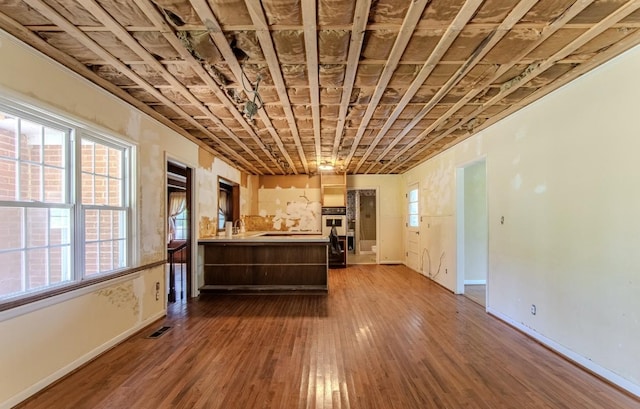 867 Lexington Hwy, Loretto, TN 38469 - unfurnished living room featuring baseboards and hardwood / wood-style flooring