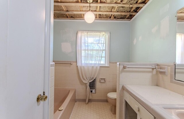 867 Lexington Hwy, Loretto, TN 38469 - full bath featuring tile walls, a tub to relax in, a wainscoted wall, tile patterned floors, and vanity
