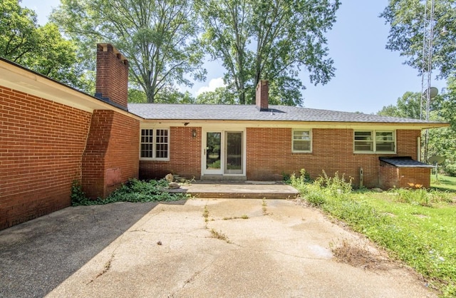 867 Lexington Hwy, Loretto, TN 38469 - rear view of property featuring a chimney, a patio, and brick siding
