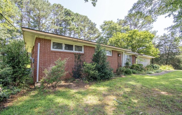 867 Lexington Hwy, Loretto, TN 38469 - ranch-style home featuring a front yard and brick siding