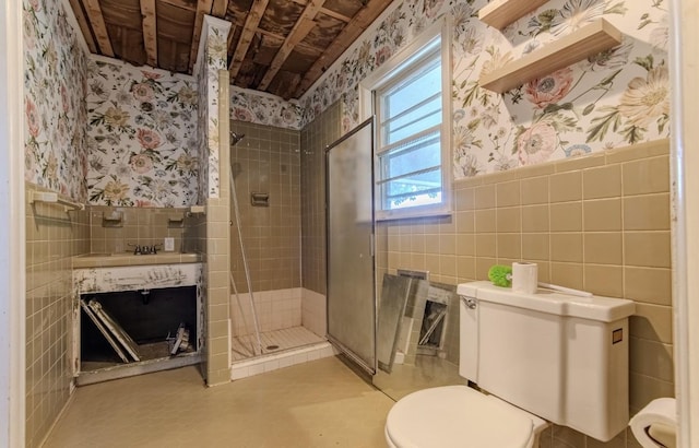 867 Lexington Hwy, Loretto, TN 38469 - full bathroom featuring wallpapered walls, tile walls, a shower stall, a wainscoted wall, and vanity