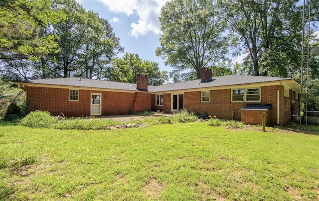 867 Lexington Hwy, Loretto, TN 38469 - back of house with a chimney, a yard, and brick siding