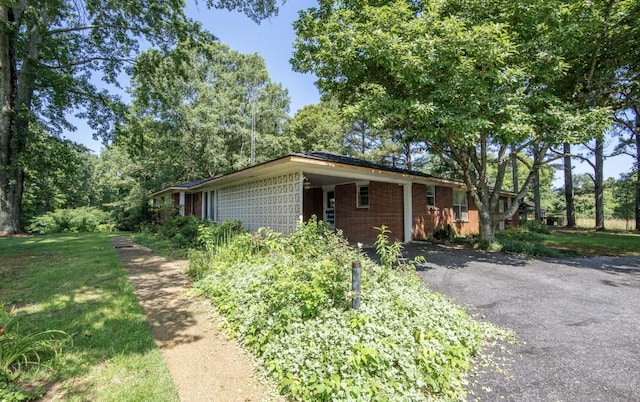 867 Lexington Hwy, Loretto, TN 38469 - view of home's exterior with driveway and brick siding