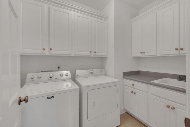 7157 Chessington Dr, Fairview, TN 37062 - washroom featuring cabinet space, washing machine and clothes dryer, and light tile patterned floors