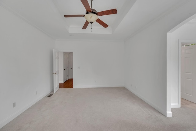 7157 Chessington Dr, Fairview, TN 37062 - empty room featuring a tray ceiling, light colored carpet, a ceiling fan, and ornamental molding