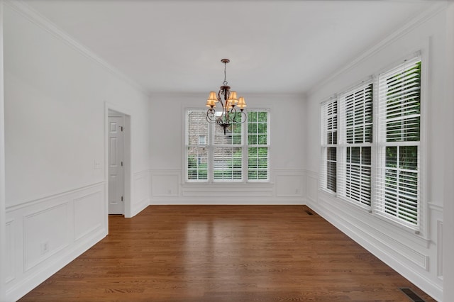 7157 Chessington Dr, Fairview, TN 37062 - unfurnished dining area featuring a chandelier, ornamental molding, wainscoting, a decorative wall, and wood finished floors