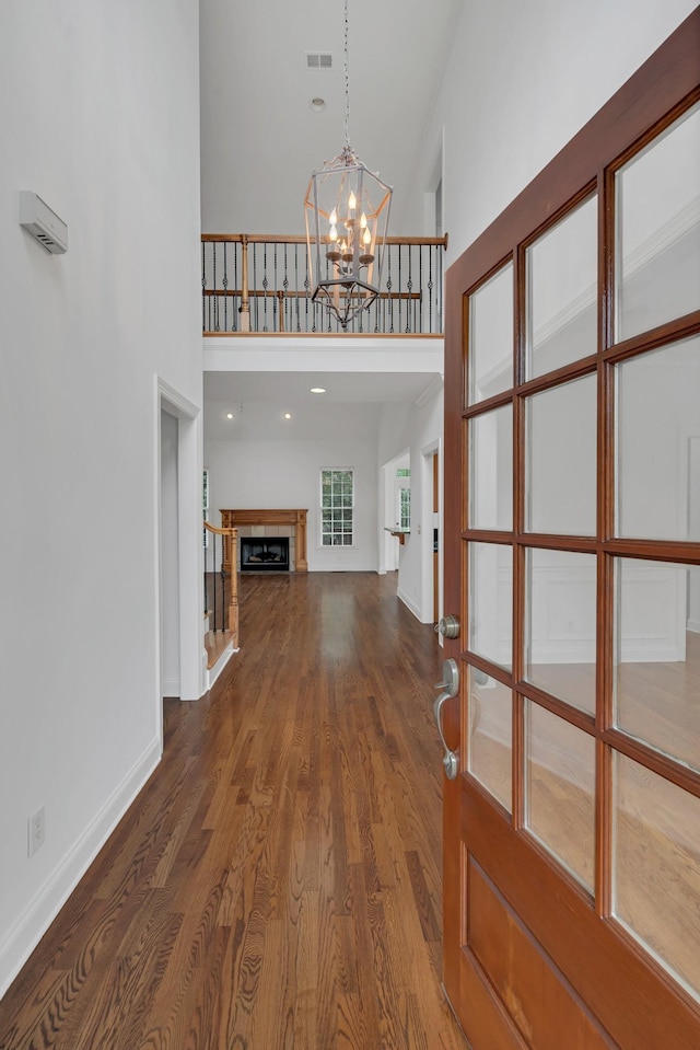 7157 Chessington Dr, Fairview, TN 37062 - entrance foyer with a high ceiling, a chandelier, dark wood-style flooring, and a fireplace