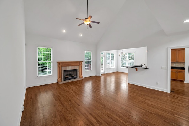 7157 Chessington Dr, Fairview, TN 37062 - unfurnished living room with high vaulted ceiling, a ceiling fan, dark wood-style floors, a tile fireplace, and recessed lighting