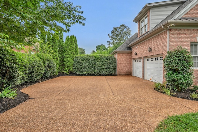 7157 Chessington Dr, Fairview, TN 37062 - view of side of property featuring brick siding, driveway, a garage, and a shingled roof