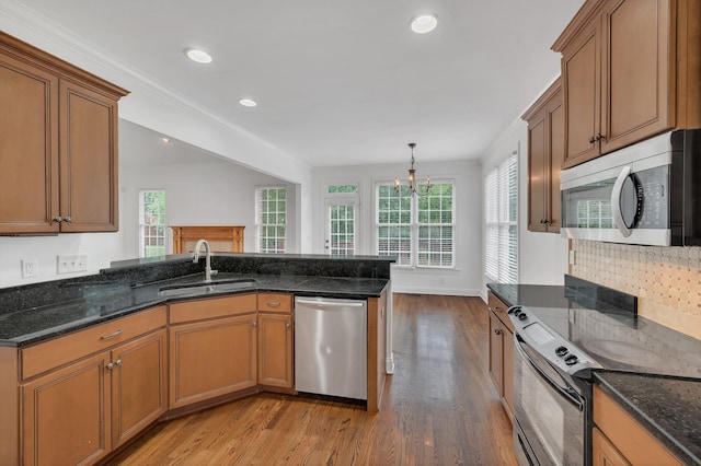 7157 Chessington Dr, Fairview, TN 37062 - kitchen with appliances with stainless steel finishes, light wood-style flooring, brown cabinetry, plenty of natural light, and recessed lighting