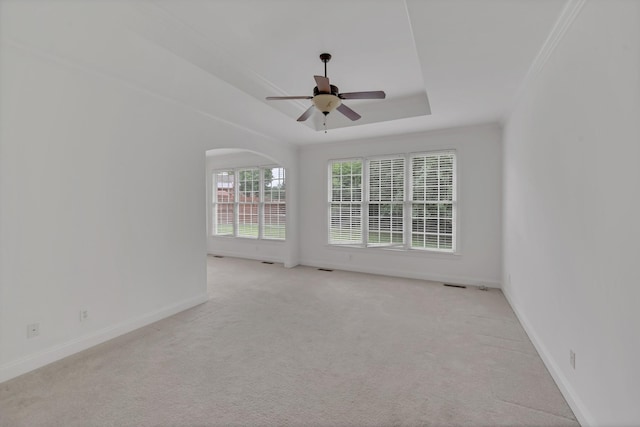 7157 Chessington Dr, Fairview, TN 37062 - spare room with a ceiling fan, light colored carpet, a raised ceiling, and arched walkways
