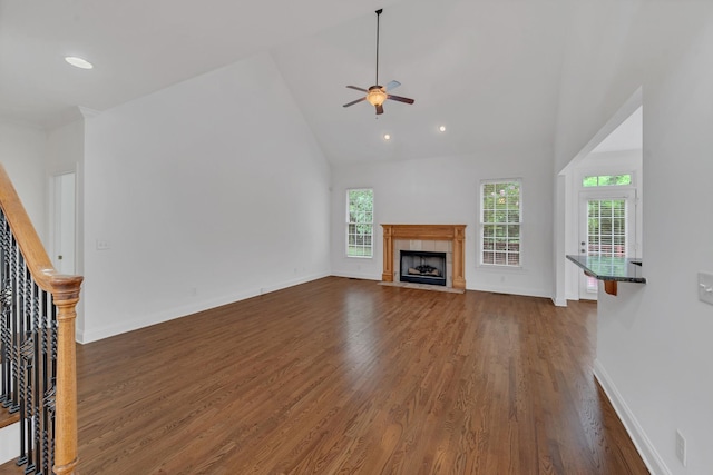 7157 Chessington Dr, Fairview, TN 37062 - unfurnished living room with dark wood-style floors, high vaulted ceiling, ceiling fan, a tile fireplace, and recessed lighting