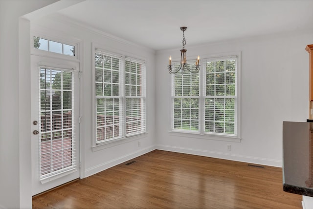 7157 Chessington Dr, Fairview, TN 37062 - unfurnished dining area with a chandelier, healthy amount of natural light, wood finished floors, and crown molding