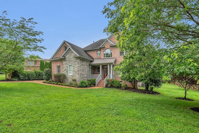 7157 Chessington Dr, Fairview, TN 37062 - craftsman inspired home featuring stone siding, a front yard, a standing seam roof, and covered porch