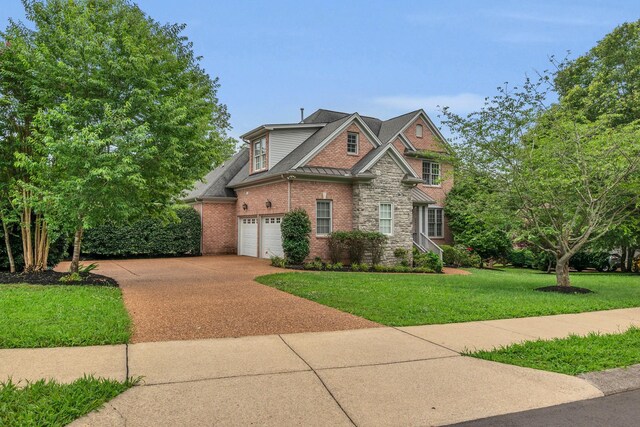 7157 Chessington Dr, Fairview, TN 37062 - view of front of home featuring driveway, a front lawn, brick siding, a garage, and stone siding