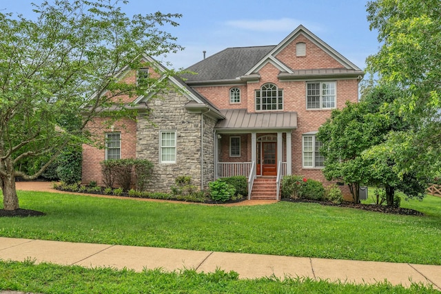 7157 Chessington Dr, Fairview, TN 37062 - view of front of house featuring a porch, a front lawn, a standing seam roof, and stone siding