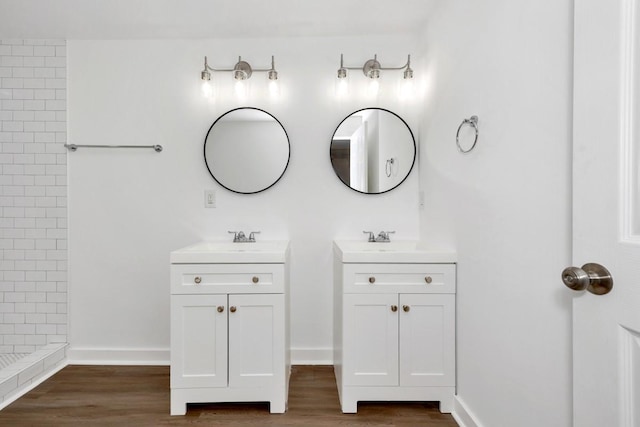 475 Kelly Creek Rd, Ardmore, TN 38449 - bathroom featuring two vanities, wood finished floors, and tiled shower
