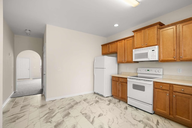 1101 Downs Blvd Unit 112, Franklin, TN 37064 - kitchen with white appliances, brown cabinetry, light marble finish floors, arched walkways, and recessed lighting
