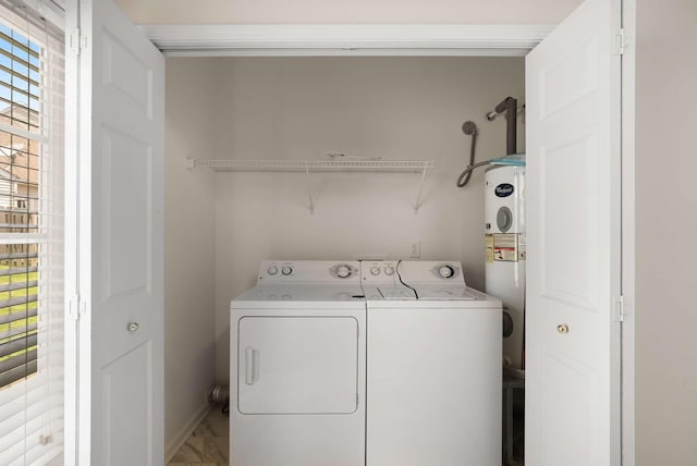 1101 Downs Blvd Unit 112, Franklin, TN 37064 - laundry area featuring separate washer and dryer, electric water heater, and light marble finish floors