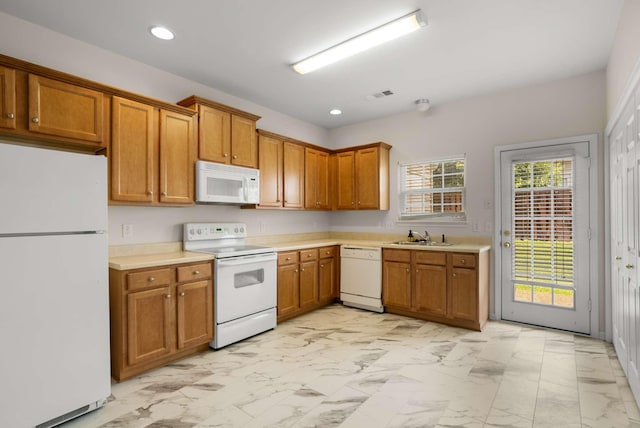 1101 Downs Blvd Unit 112, Franklin, TN 37064 - kitchen with white appliances, light marble finish floors, brown cabinetry, light countertops, and recessed lighting