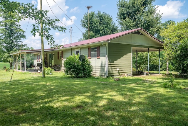 399 Indian Creek Rd, Hohenwald, TN 38462 - view of home's exterior with a lawn, a metal roof, and a patio
