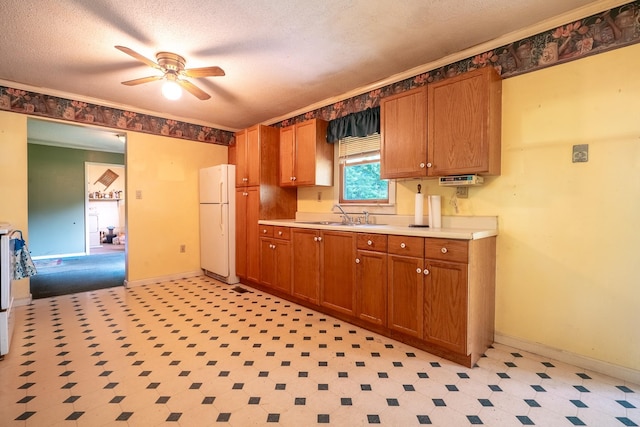 399 Indian Creek Rd, Hohenwald, TN 38462 - kitchen featuring freestanding refrigerator, ceiling fan, light countertops, light floors, and brown cabinetry