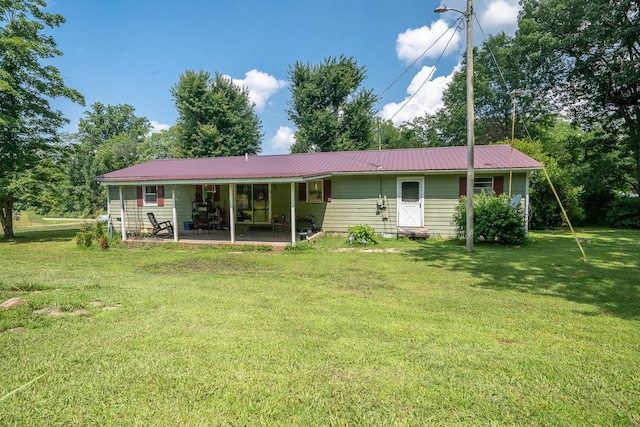 399 Indian Creek Rd, Hohenwald, TN 38462 - back of house featuring a yard, a patio, and a metal roof