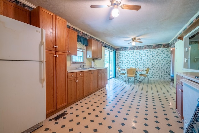 399 Indian Creek Rd, Hohenwald, TN 38462 - kitchen with freestanding refrigerator, ceiling fan, light floors, a textured ceiling, and light countertops