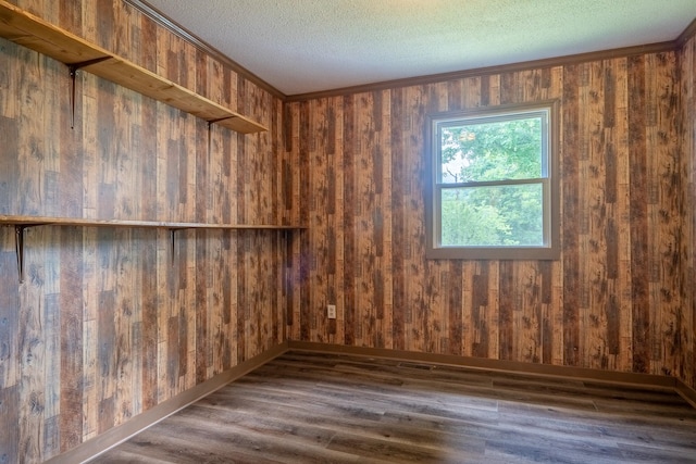 399 Indian Creek Rd, Hohenwald, TN 38462 - spare room with wood finished floors, wooden walls, and a textured ceiling